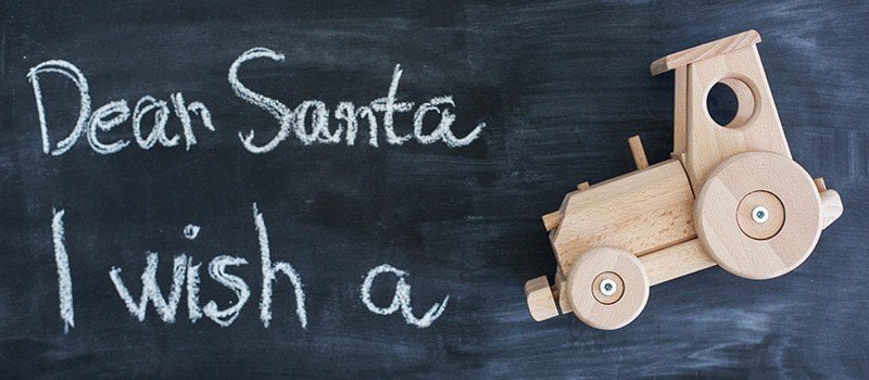 Dear Santa is written on a blackboard and christmas gift